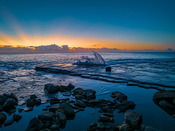 Sunrise over the blue sea and rocky Inlet