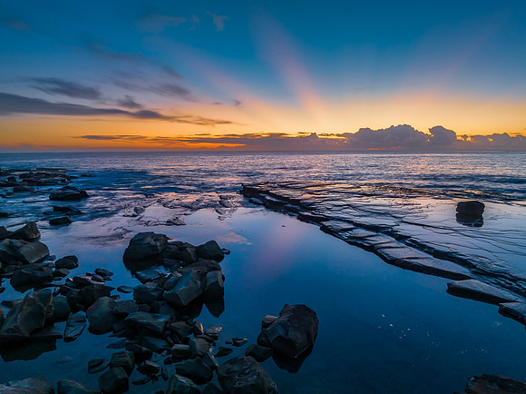 Sunrise over the blue sea and rocky Inlet