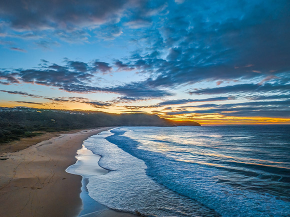 Surf, sea, sand, sunrise with clouds