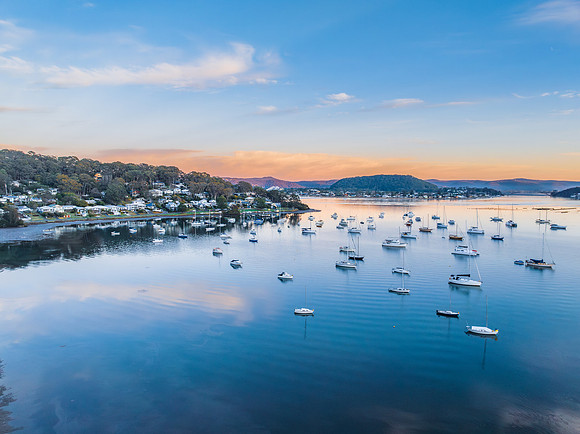Sunrise blues with boats on the bay