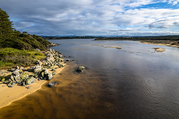 A cloud covered winters morning where the river meets the sea in