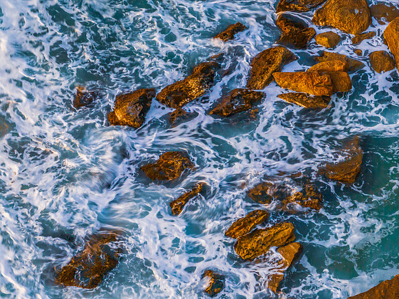 Surf, sea, sand, rocks, sunrise at the beach