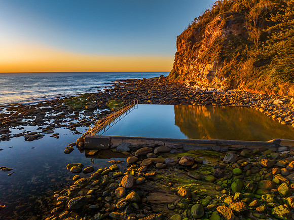 Clear skies and flat surf sunrise seascape