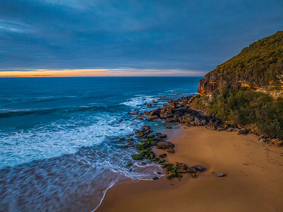 Surf, sea, sand, sunrise with clouds