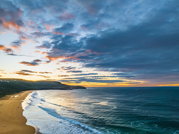 Surf, sea, sand, sunrise with clouds