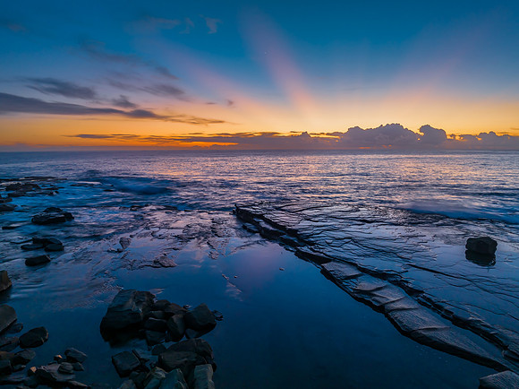 Sunrise over the blue sea and rocky Inlet