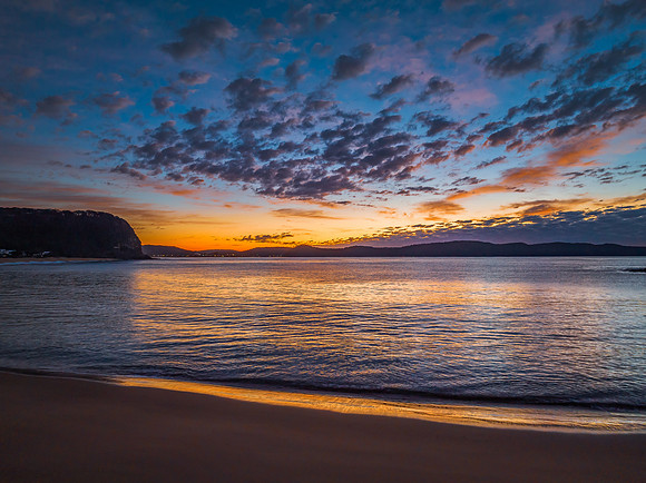 Aerial sunrise seascape with pretty cloud filled sky