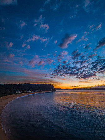 Aerial sunrise seascape with pretty cloud filled sky