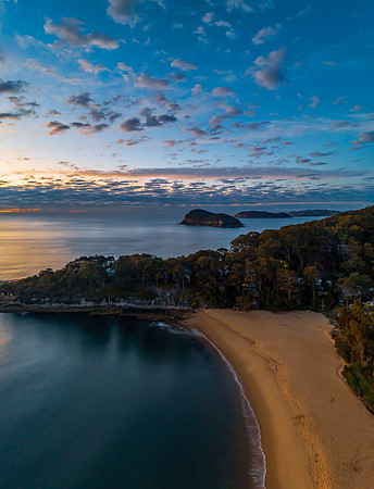 Aerial sunrise seascape with pretty cloud filled sky