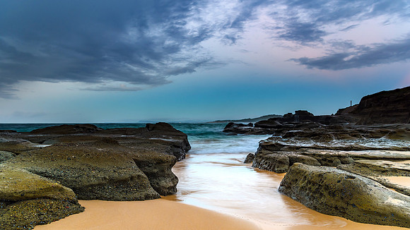 Rocky Shore and Overcast Sunrise Seascape