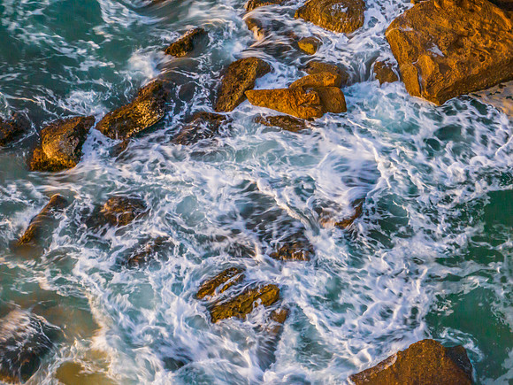 Surf, sea, sand, rocks, sunrise at the beach