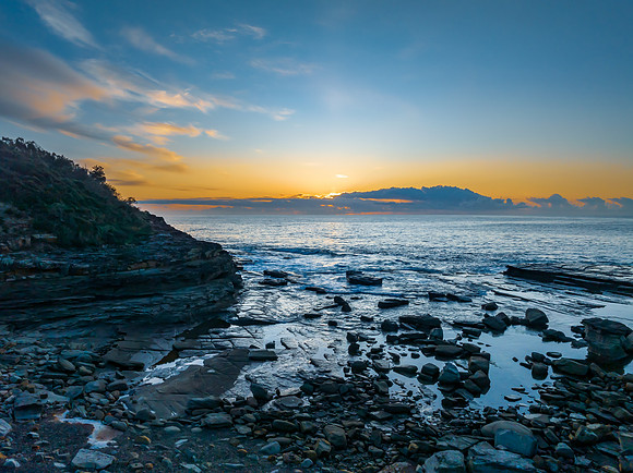 Sunrise over the blue sea and rocky Inlet