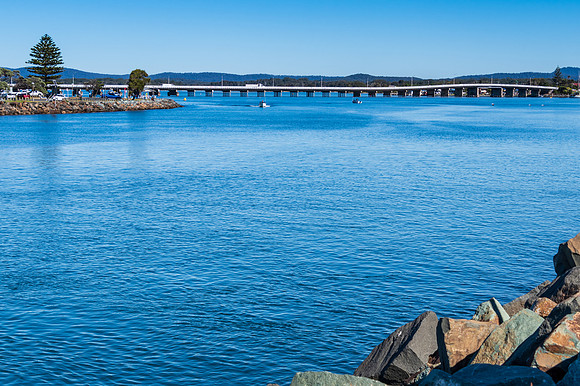 The blue river leading into the sea and bridge joining two towns