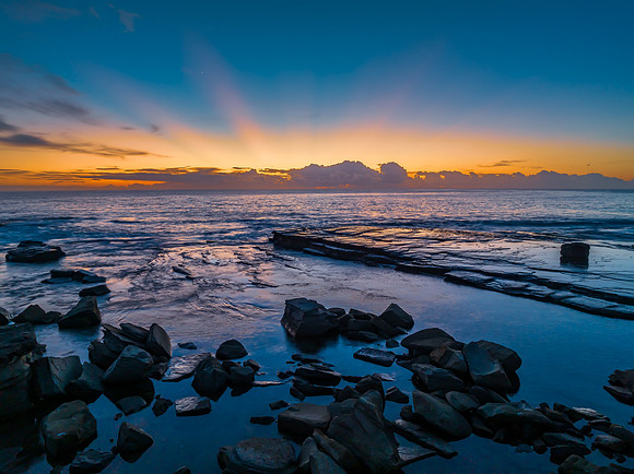 Sunrise over the blue sea and rocky Inlet