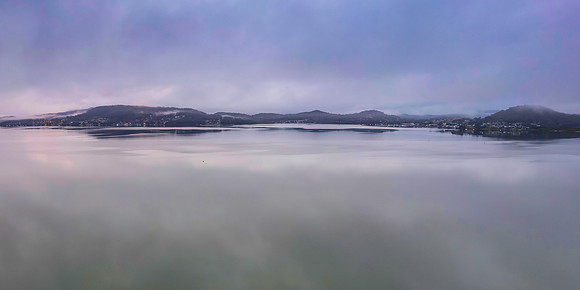 Cloud covered aerial waterscape with boats