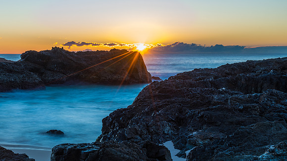 Sunrise seascape and a rocky beach