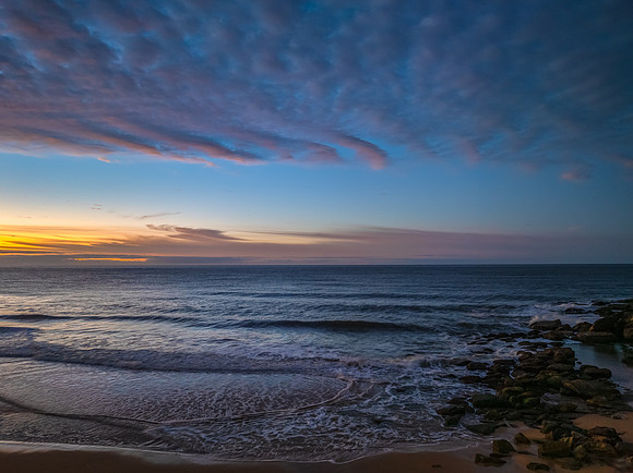 Winter seascape views over the beach with high and medium cloud