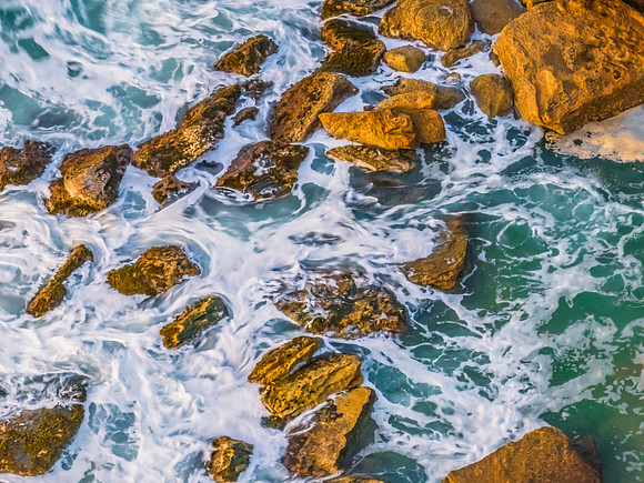 Surf, sea, sand, rocks, sunrise at the beach