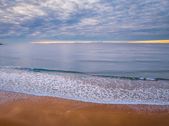 Stratus cloud filled sunrise over the ocean