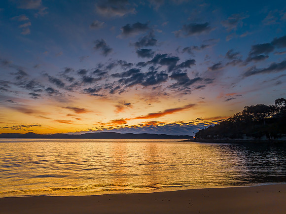 Aerial sunrise seascape with pretty cloud filled sky