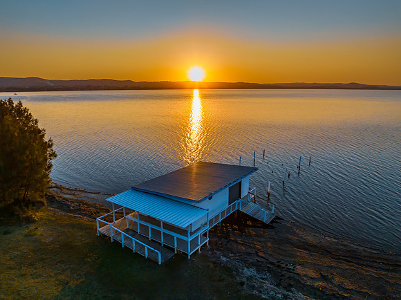 Sunset over the lake and boathouse