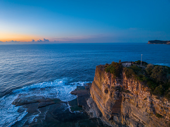 Sunrise over the blue sea and rocky Inlet
