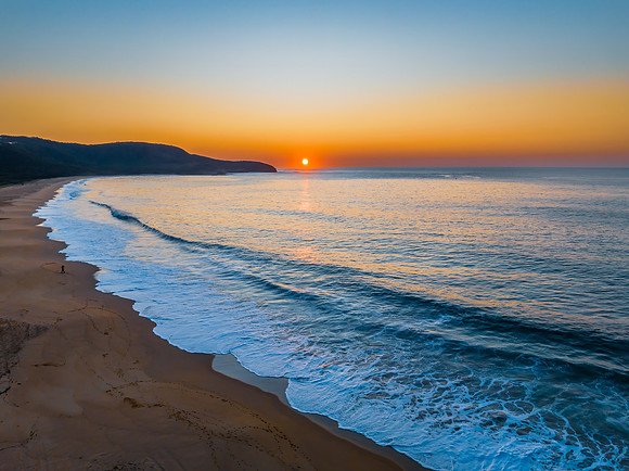 Soft sunrise seascape with hazy cloudless sky