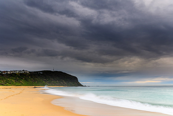 Overcast Morning Beach Scene with Headland