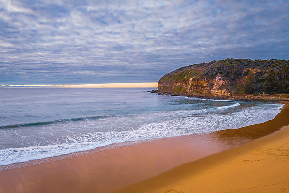Stratus cloud filled sunrise over the ocean