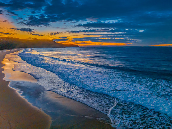 Surf, sea, sand, sunrise with clouds