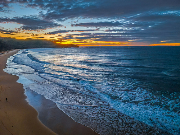 Surf, sea, sand, sunrise with clouds