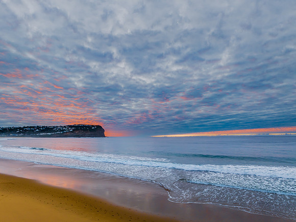 Stratus cloud filled sunrise over the ocean