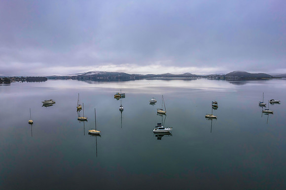 Cloud covered aerial waterscape with boats
