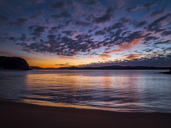 Aerial sunrise seascape with pretty cloud filled sky