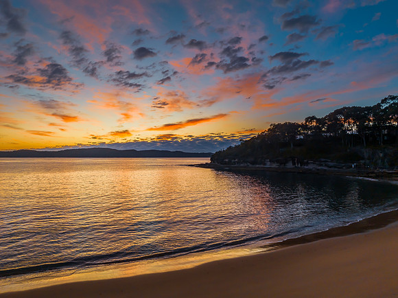 Aerial sunrise seascape with pretty cloud filled sky