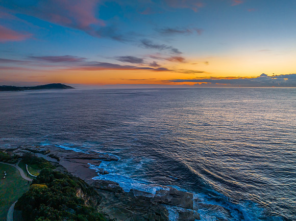 Sunrise over the blue sea and rocky Inlet
