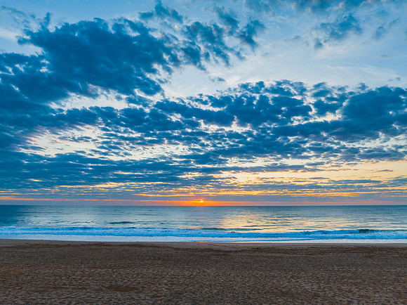 Sunrise at the seaside with clouds