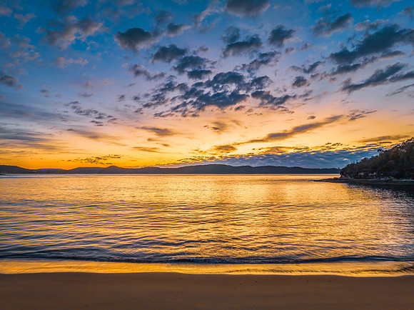 Aerial sunrise seascape with pretty cloud filled sky