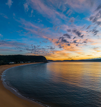 Aerial sunrise seascape with pretty cloud filled sky