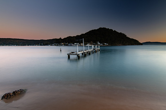 Sunset waterscape and old wharf