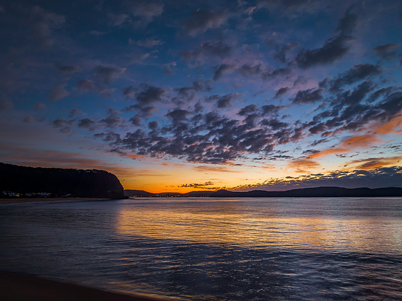 Aerial sunrise seascape with pretty cloud filled sky
