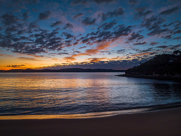 Aerial sunrise seascape with pretty cloud filled sky