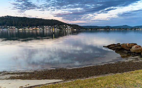 Cloudy Reverse Sunrise Waterscape over the Bay