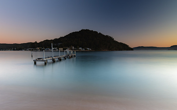 Sunset waterscape and old wharf