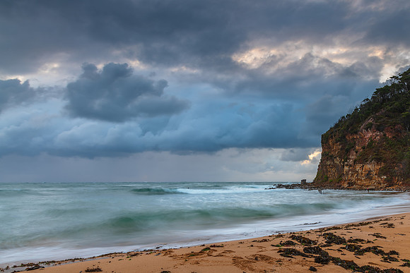 Wet weather sunrise with choppy waves at the seaside