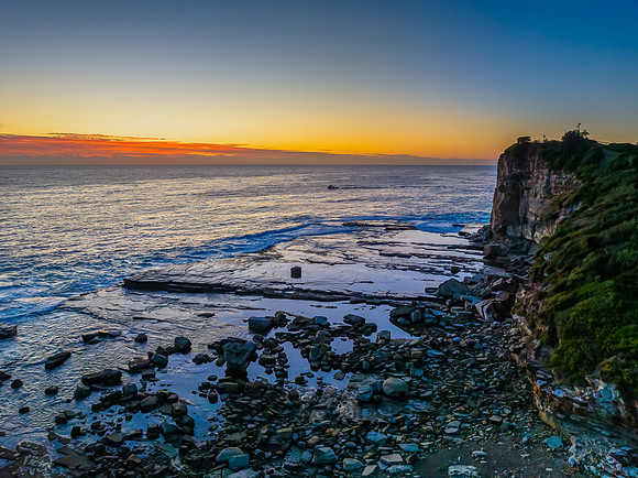 Sunrise blues over the sea and rocky Inlet