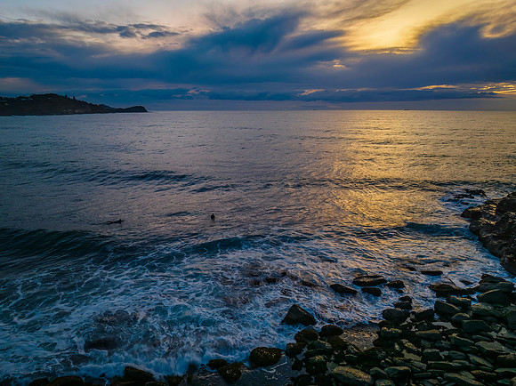 Aerial sunrise at the seaside in shades of blue and grey