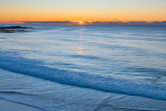 Sunrise seascape with rock platform