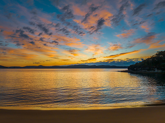 Aerial sunrise seascape with pretty cloud filled sky