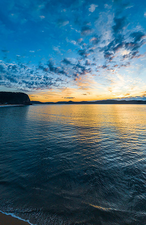 Aerial sunrise seascape with pretty cloud filled sky